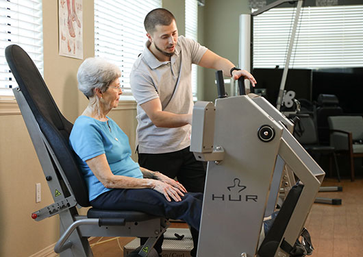 Senior woman working with a Physical Trainer to start her rehab routine.
